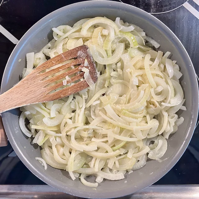 Sliced onions, cooking in melted butter
